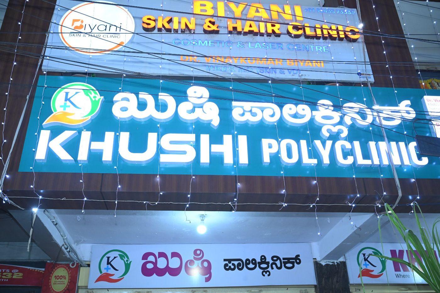 The Khushi Polyclinic board in Kannada and English on Hyderabad Road.